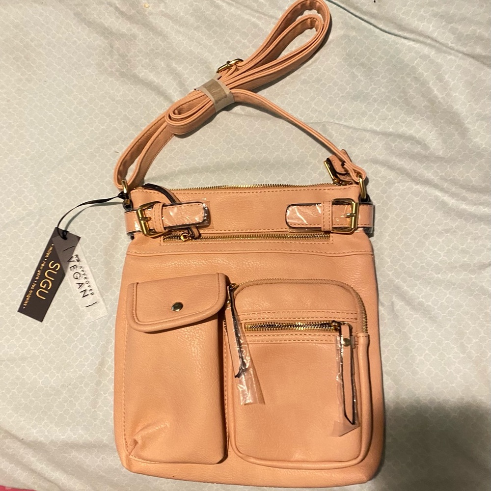 New with tags Crossbody bag. 12inLx11Wx1.5D W many pockets